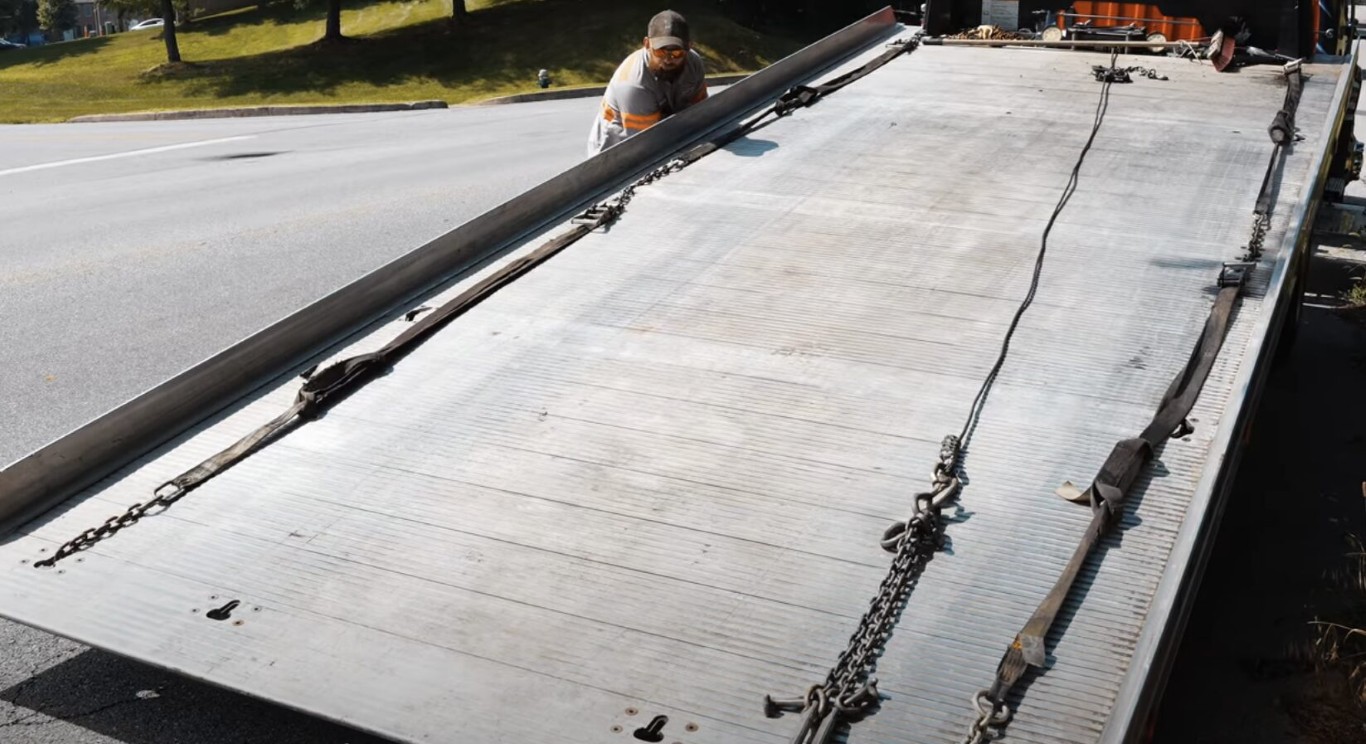 Flatbed towing service showing professional vehicle transport methods